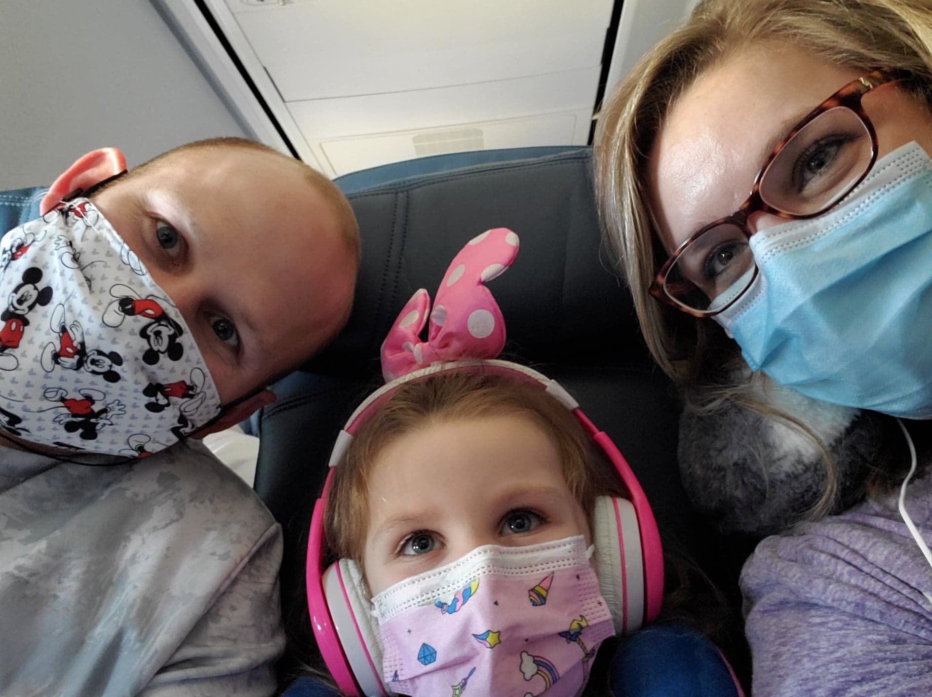 Airplane Selfie of Family with Face Masks