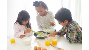 Kids cooking eggs together