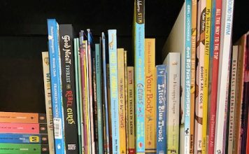 Shows bookshelf full of different colored picture books.